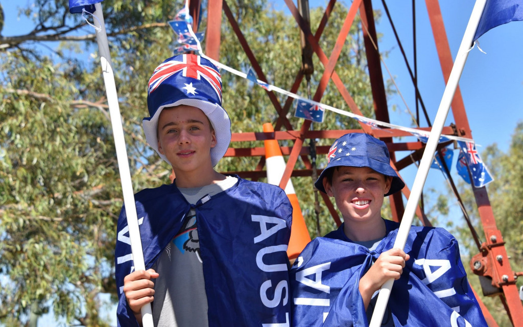 Two boys holding Aussie flags