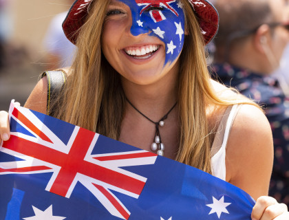 Woman with Australia Day flag and face paint