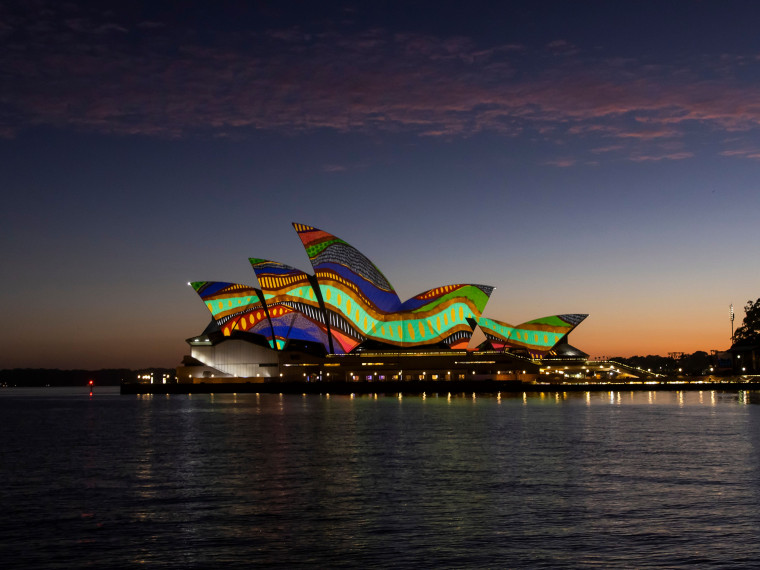 Artwork by Frances Belle-Parker projected on the sails of the Sydney Opera House at dawn