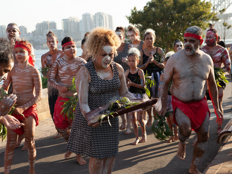Transporting the fire from the foreshore to the lawns for the the Wugulora Indigenous Morning Ceremony