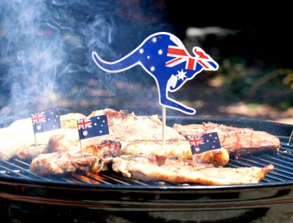 Meat cooking on a BBQ with a kangaroo shaped Australian Flag toothpick