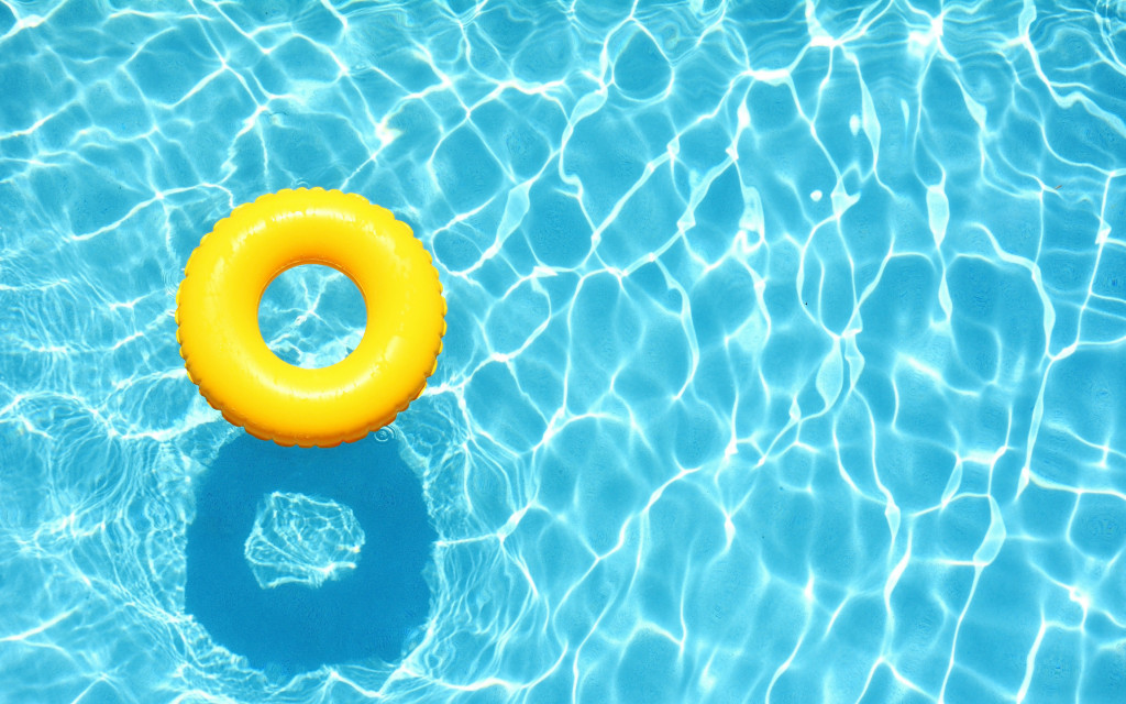 Yellow blow up donut floating in a pool